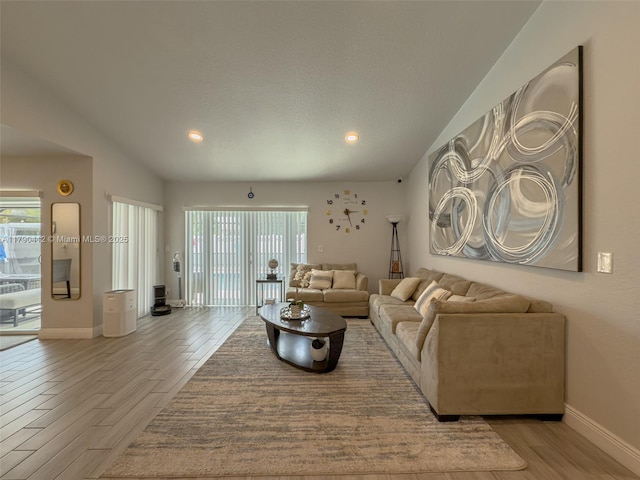 living area with a healthy amount of sunlight, light wood-type flooring, and baseboards
