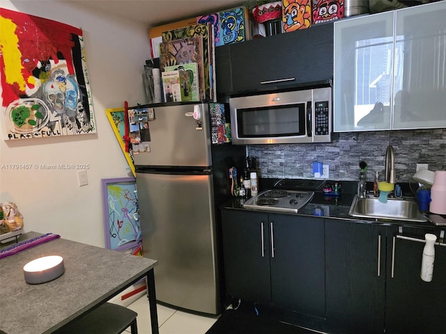 1750 N Bayshore Dr Unit 1120, Miami, FL 33132 - kitchen with appliances with stainless steel finishes, tasteful backsplash, dark cabinetry, and a sink