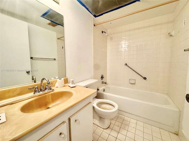 bathroom with tile patterned floors, toilet, vanity, and  shower combination