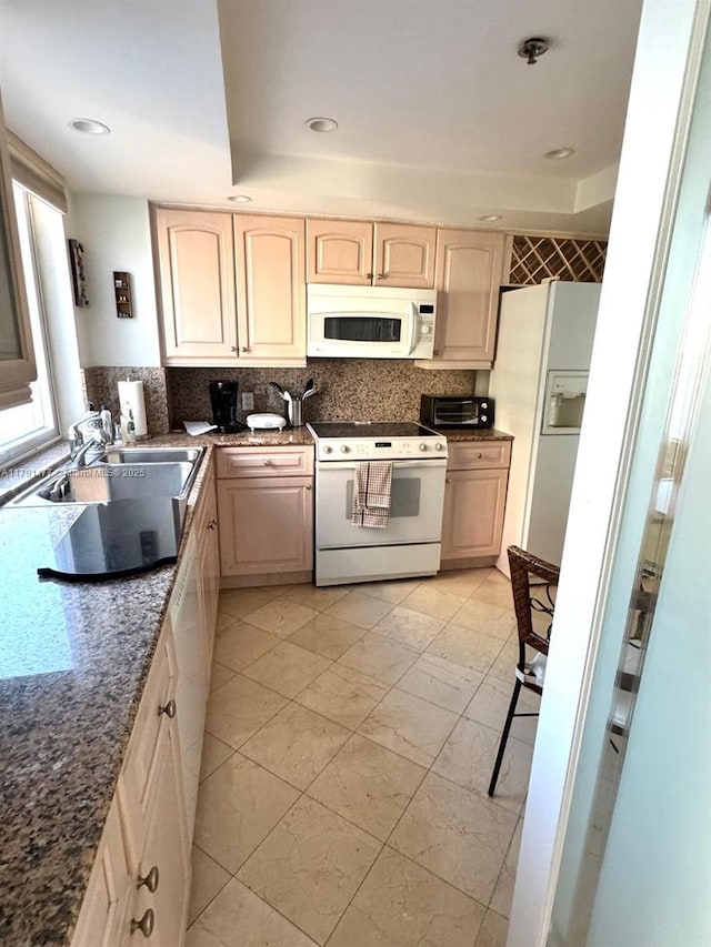 1627 Brickell Ave Unit 2005, Miami, FL 33129 - kitchen with backsplash, a toaster, dark stone countertops, recessed lighting, and white appliances