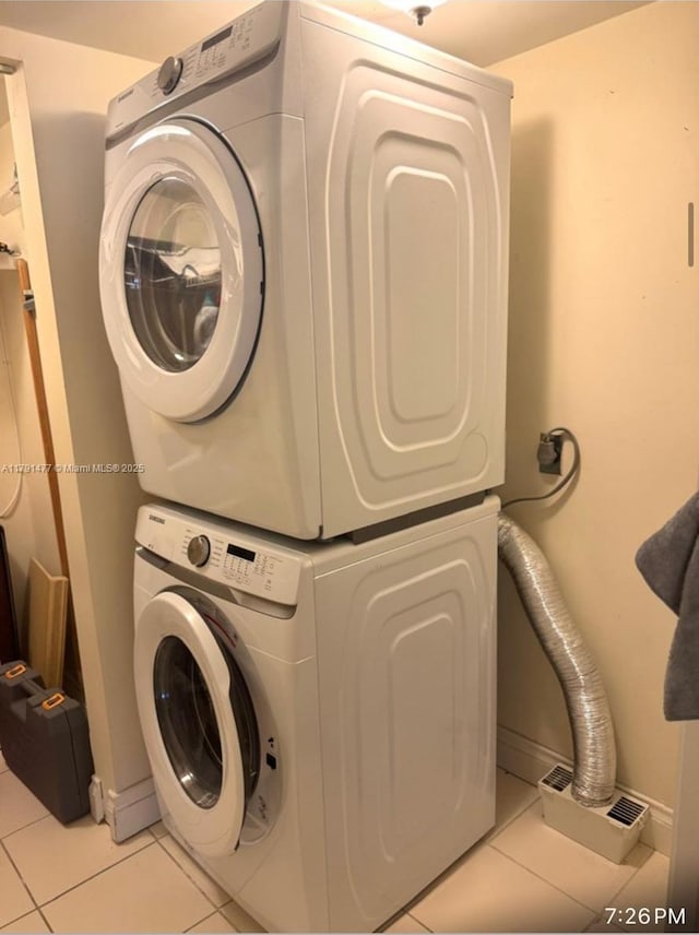 1627 Brickell Ave Unit 2005, Miami, FL 33129 - washroom with light tile patterned floors, baseboards, and stacked washer / dryer