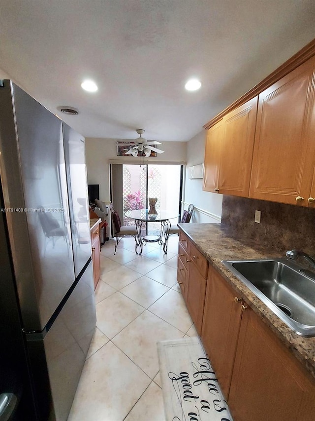 21338 Juego Cir Unit 11C, Boca Raton, FL 33433 - kitchen featuring freestanding refrigerator, a sink, recessed lighting, light tile patterned flooring, and brown cabinetry
