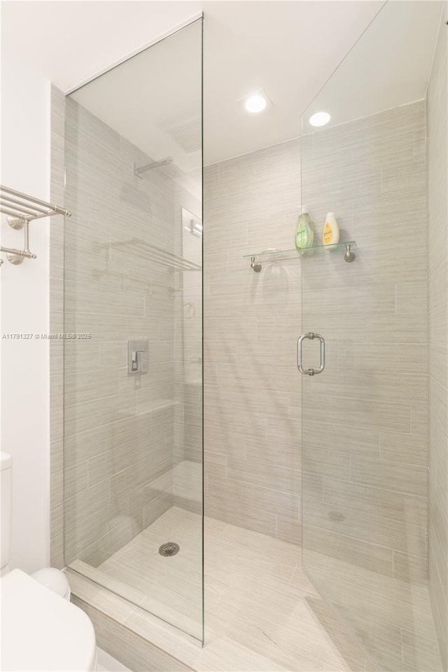 full bath with toilet, recessed lighting, and a stall shower