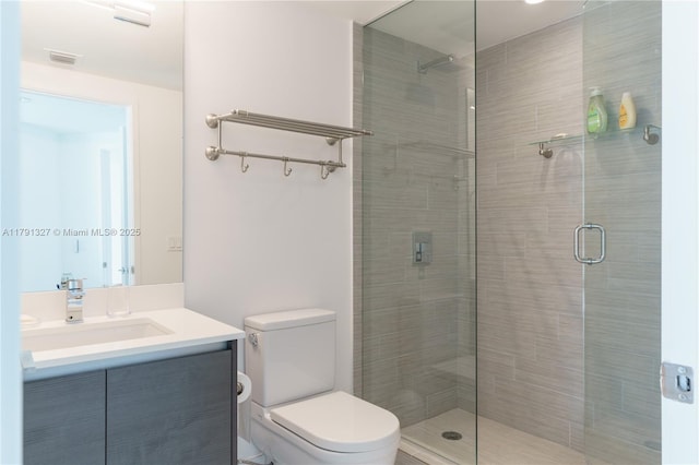 full bathroom with toilet, a stall shower, visible vents, and vanity