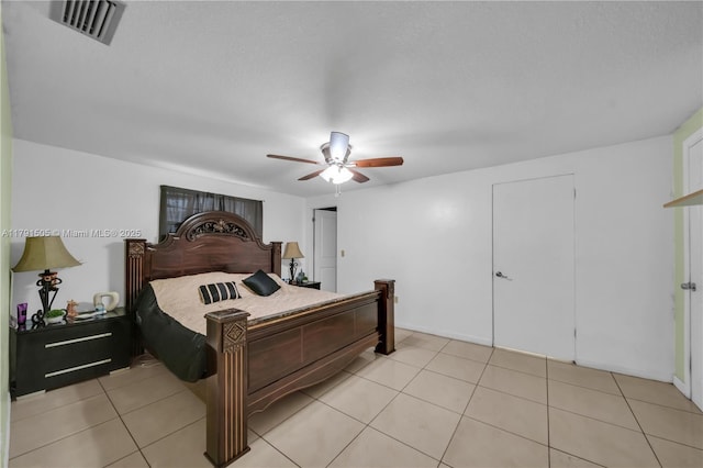 bedroom featuring light tile patterned floors, visible vents, and a ceiling fan