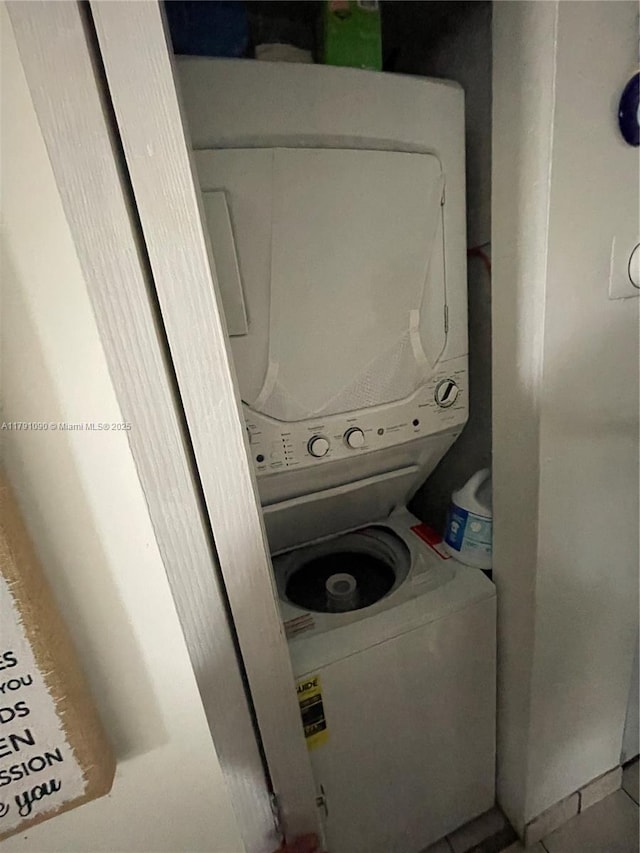 9520 SW 8th St Unit 211, Miami, FL 33174 - laundry area with tile patterned floors, stacked washer and dryer, and laundry area