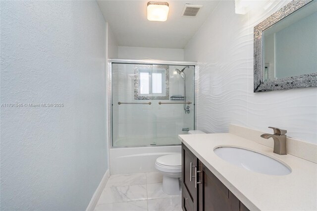 bathroom featuring baseboards, marble finish floor, and vanity
