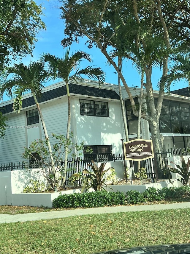 view of front of home featuring stucco siding and fence