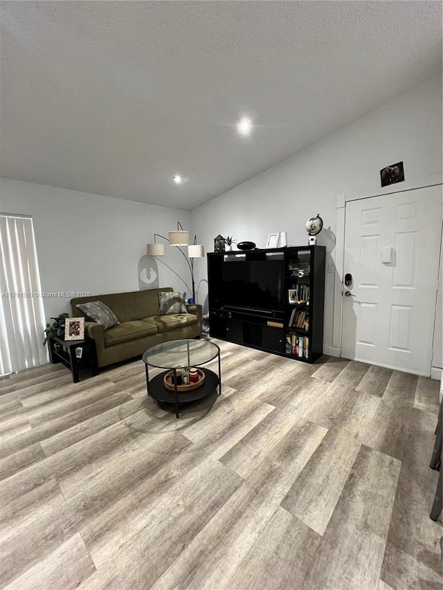 living room featuring a textured ceiling, wood finished floors, and recessed lighting