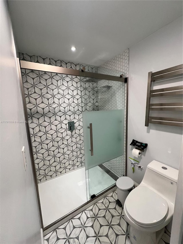 bathroom with recessed lighting, a shower stall, and toilet