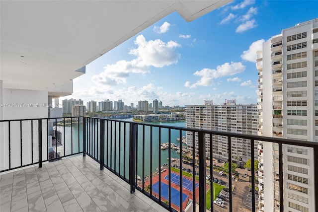 balcony featuring a view of city and a water view