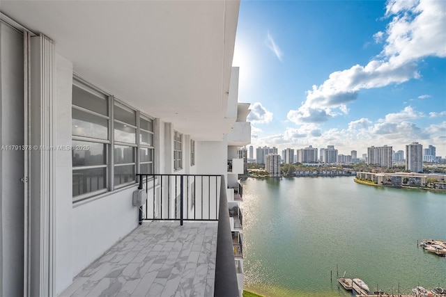 balcony featuring a water view and a city view