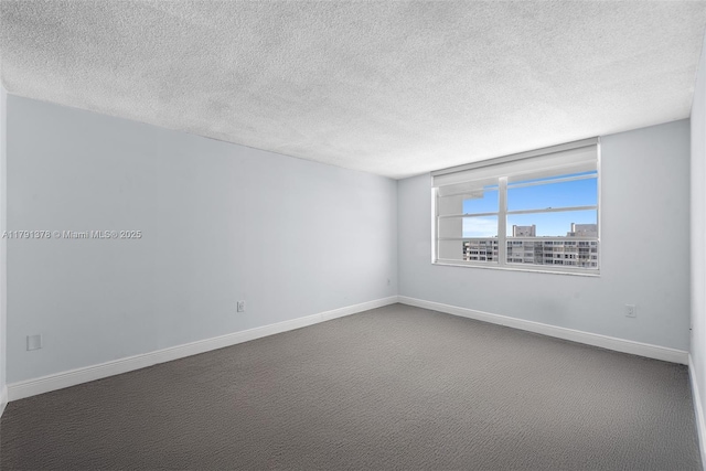 unfurnished room featuring a textured ceiling and baseboards
