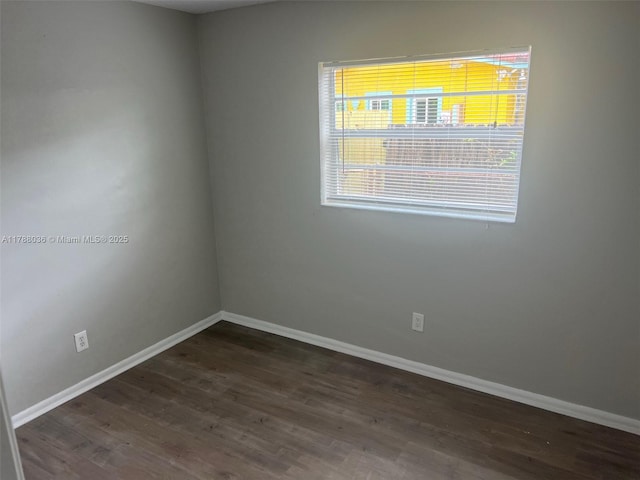 4410 NW 30th Ct, Lauderdale Lakes, FL 33313 - empty room with baseboards and dark wood-type flooring