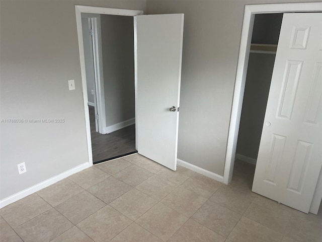 4410 NW 30th Ct, Lauderdale Lakes, FL 33313 - unfurnished bedroom with light tile patterned floors, a closet, and baseboards
