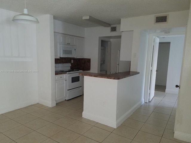15231 SW 80th St Unit 209, Miami, FL 33193 - kitchen with light tile patterned floors, visible vents, white appliances, dark countertops, and white cabinets