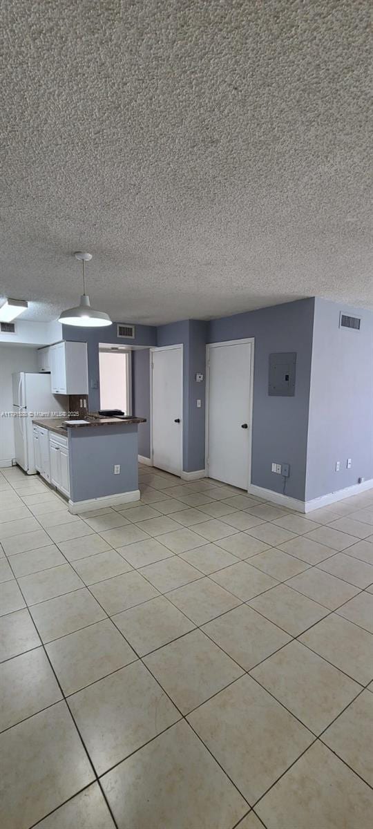 15231 SW 80th St Unit 209, Miami, FL 33193 - kitchen with light tile patterned flooring, visible vents, freestanding refrigerator, and baseboards