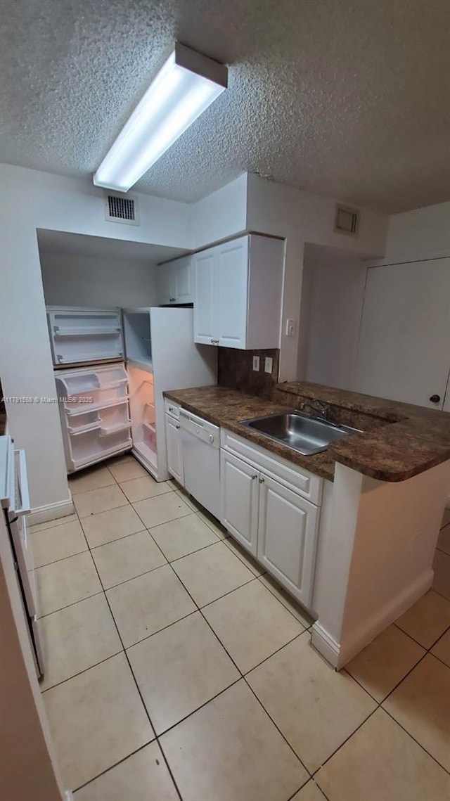 15231 SW 80th St Unit 209, Miami, FL 33193 - kitchen with a textured ceiling, dishwasher, white cabinets, and visible vents