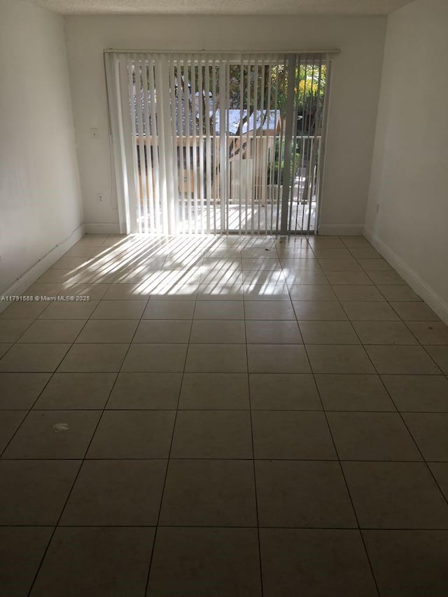 15231 SW 80th St Unit 209, Miami, FL 33193 - spare room featuring tile patterned floors and baseboards