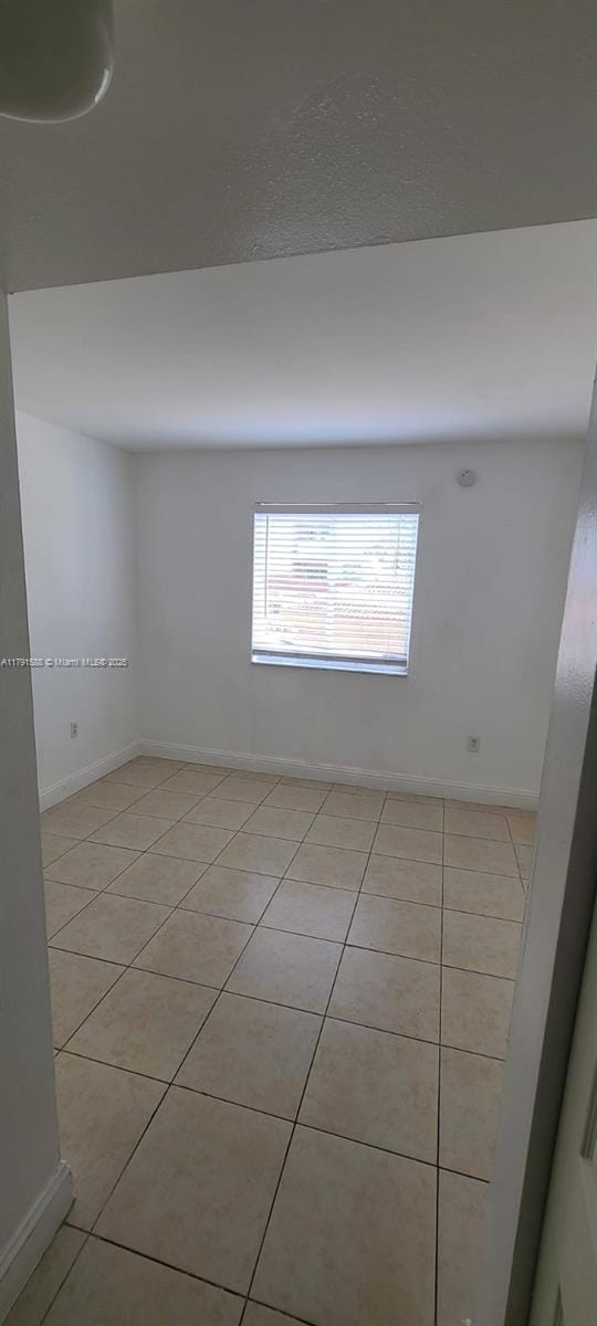 15231 SW 80th St Unit 209, Miami, FL 33193 - empty room featuring baseboards and light tile patterned floors