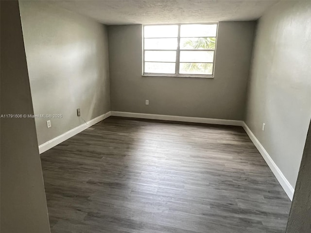 7000 NW 17th St Unit 109, Plantation, FL 33313 - empty room with a textured ceiling, baseboards, and dark wood-type flooring