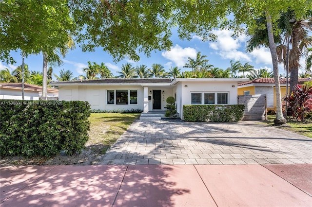 ranch-style home with fence and stucco siding