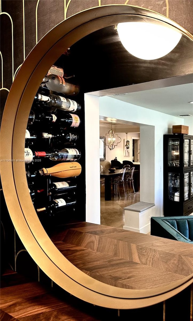 wine room with a notable chandelier and wine cooler