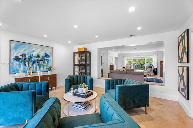 living area featuring light tile patterned flooring, visible vents, recessed lighting, and baseboards