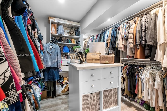 walk in closet with light wood-type flooring