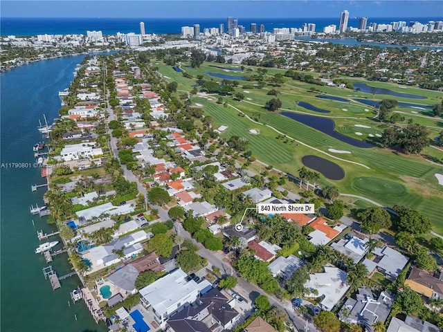 aerial view featuring a view of city, golf course view, and a water view
