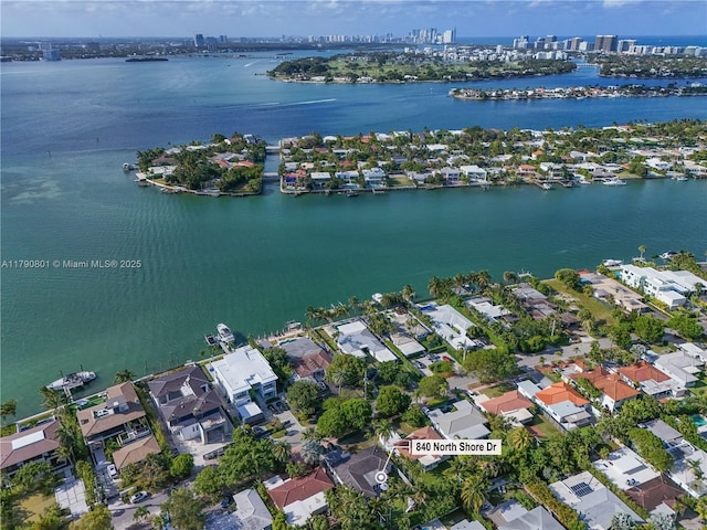 birds eye view of property with a residential view, a water view, and a view of city