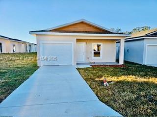 1429 Las Villas Blvd, Sebring, FL 33870 - ranch-style home with an attached garage and concrete driveway
