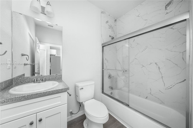 1429 Las Villas Blvd, Sebring, FL 33870 - bathroom featuring vanity, shower / bath combination with glass door, and wood finished floors
