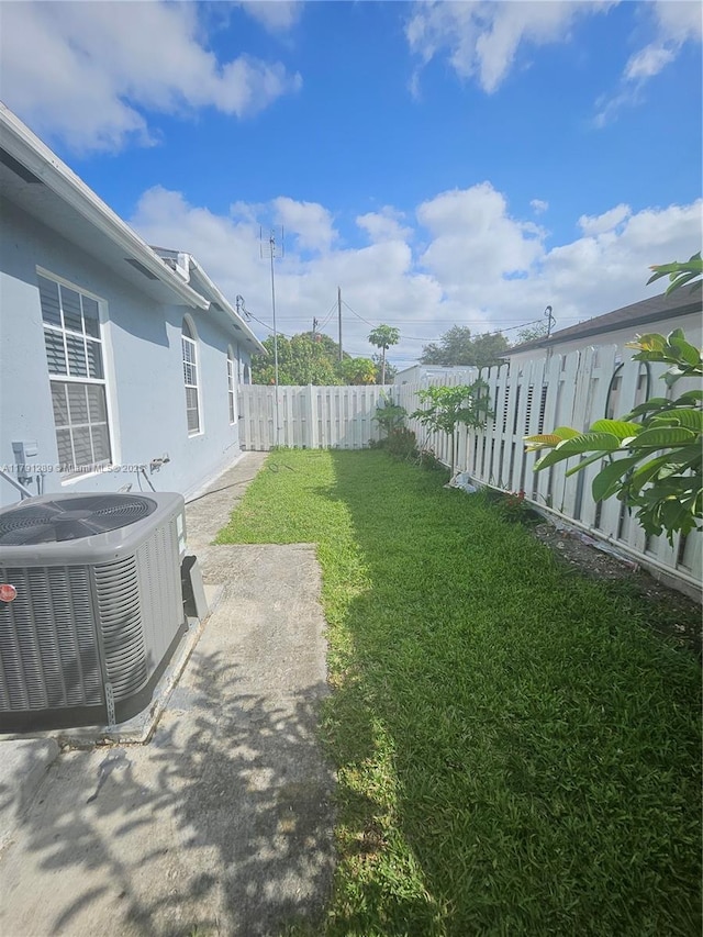 view of yard featuring a fenced backyard and central AC unit