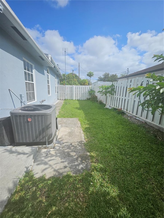 view of yard featuring a fenced backyard and central air condition unit