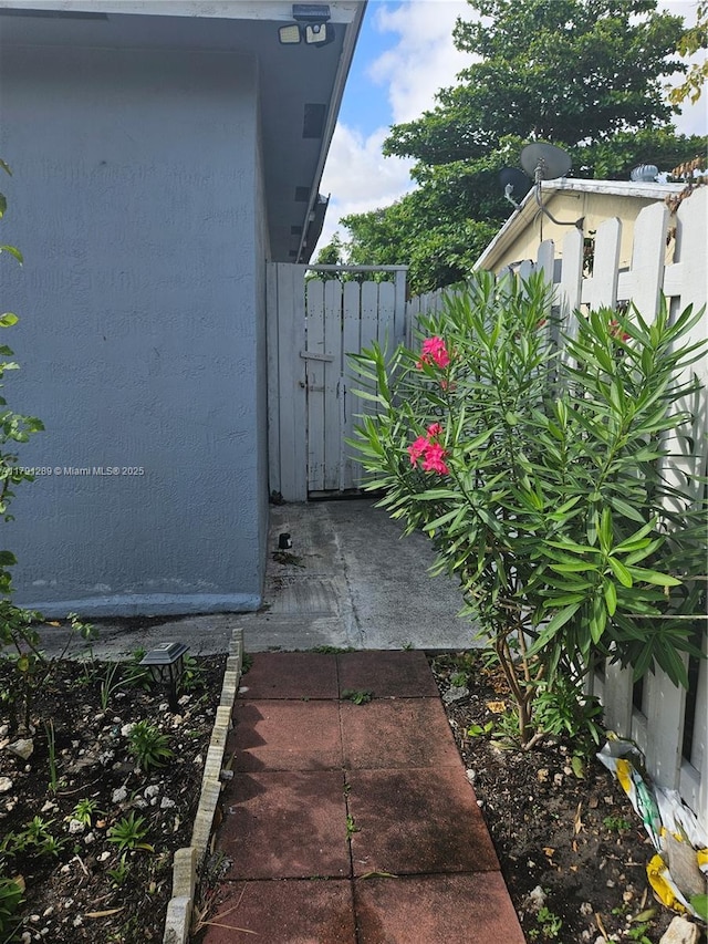 exterior details with stucco siding and fence