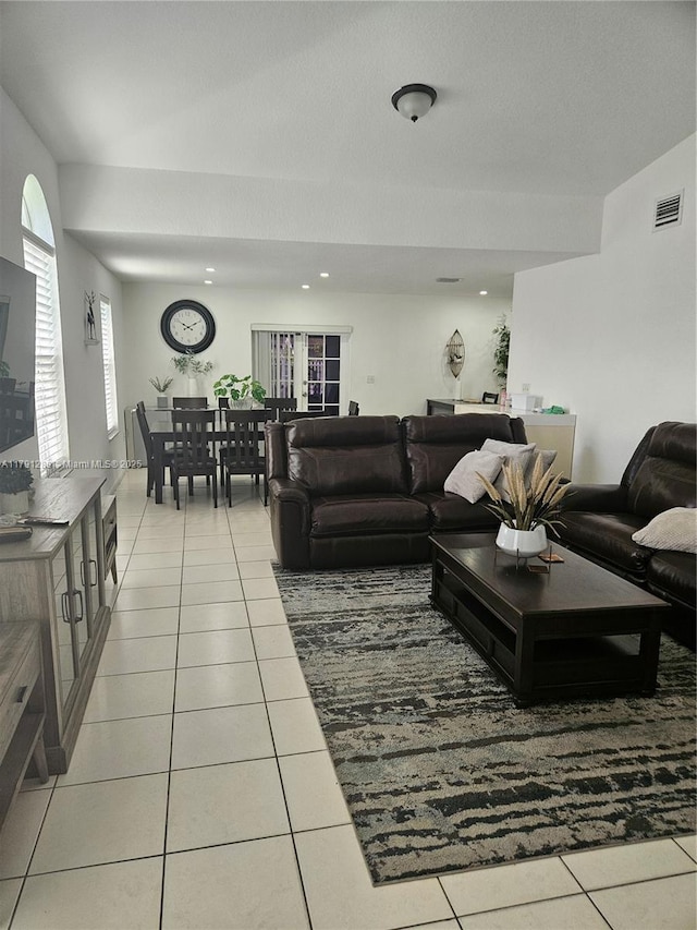 living room featuring visible vents and light tile patterned flooring