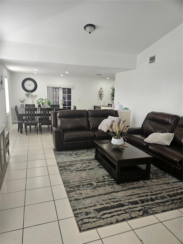 tiled living room featuring visible vents and recessed lighting