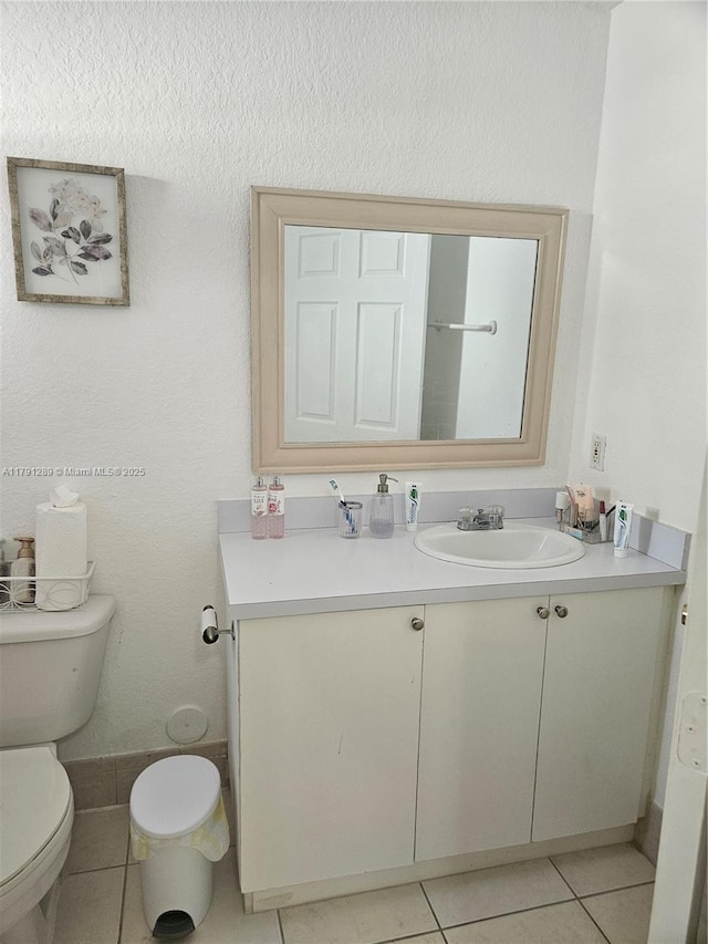 bathroom featuring tile patterned floors, toilet, and vanity