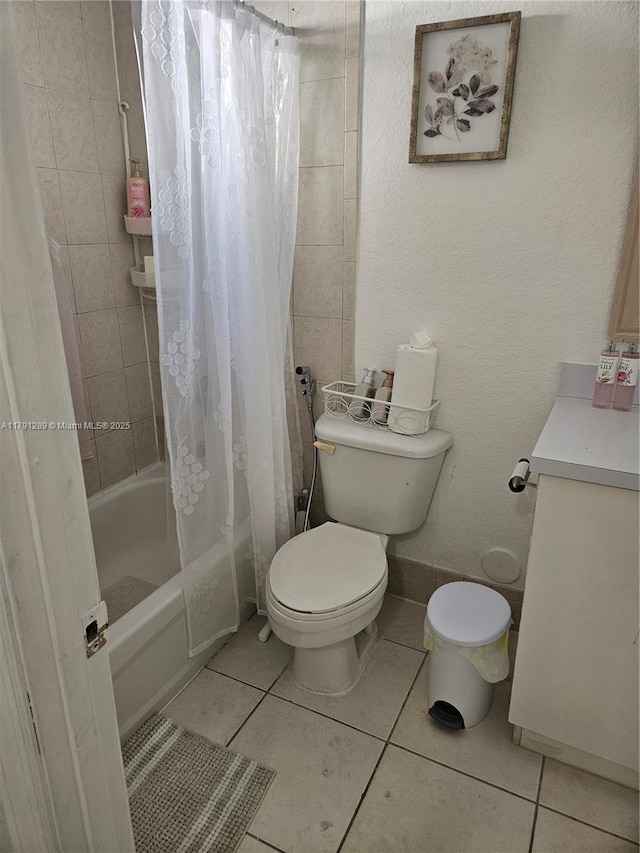 full bath with shower / tub combo, toilet, tile patterned flooring, and vanity
