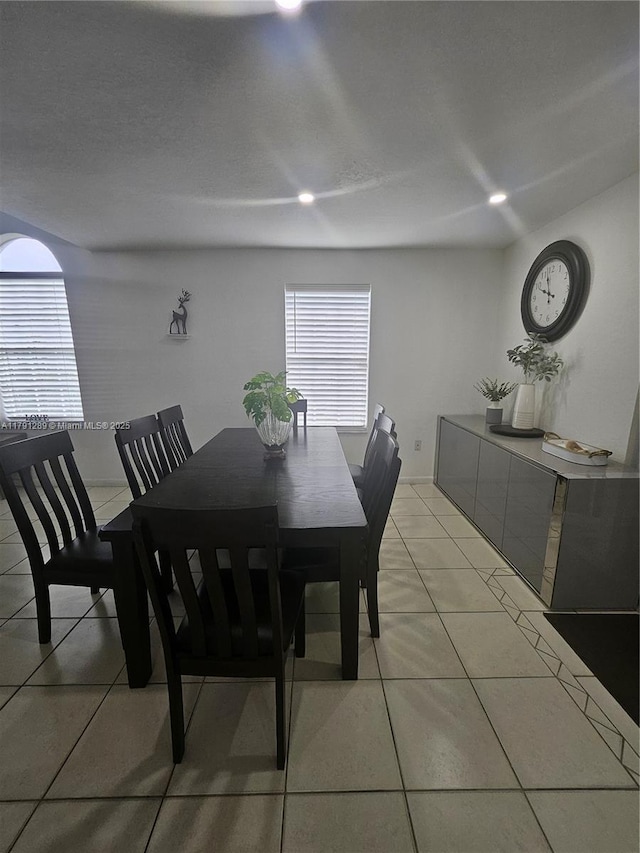 dining room with light tile patterned flooring and recessed lighting