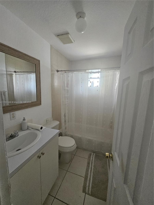 full bathroom with shower / bath combo, vanity, tile patterned floors, toilet, and visible vents