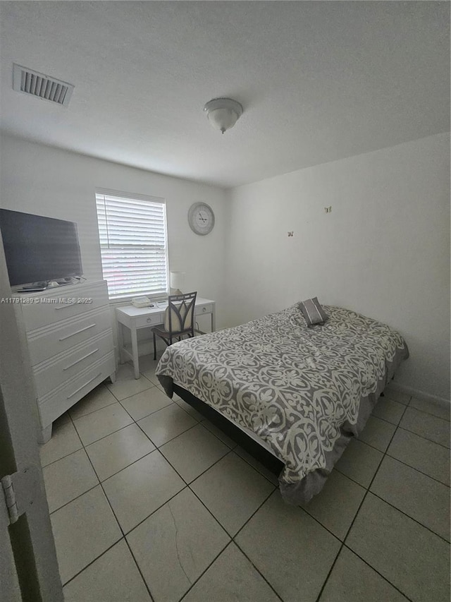 bedroom featuring visible vents and light tile patterned floors