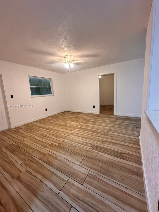 249 SW 4th Ct, Homestead, FL 33030 - unfurnished room featuring ceiling fan, wood tiled floors, a textured ceiling, and baseboards