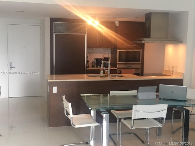 485 Brickell Ave Unit 1903, Miami, FL 33131 - kitchen featuring stainless steel double oven, black electric cooktop, range hood, and a sink