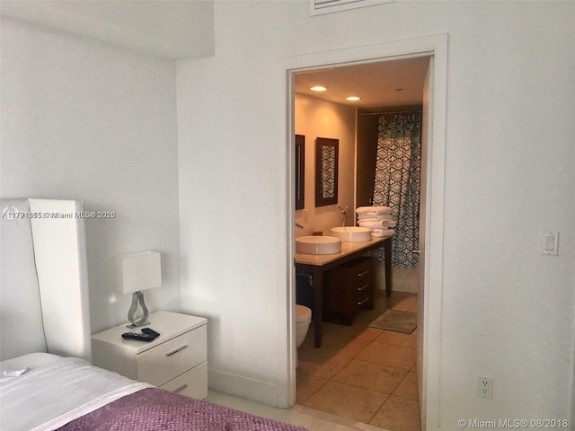 485 Brickell Ave Unit 1903, Miami, FL 33131 - bedroom with recessed lighting, light tile patterned floors, connected bathroom, and a sink