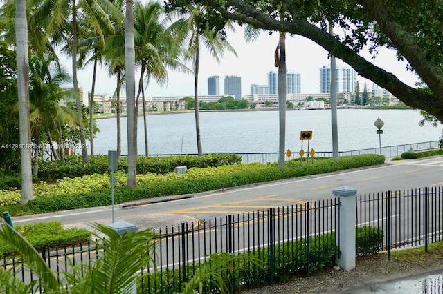 view of water feature featuring a view of city and fence