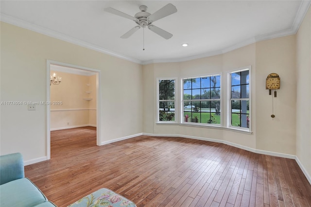 unfurnished living room featuring crown molding, baseboards, a ceiling fan, and hardwood / wood-style flooring