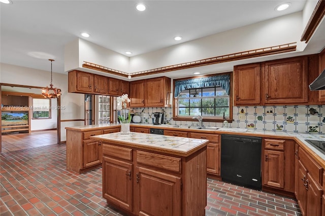 kitchen featuring brick floor, a center island, a sink, black appliances, and tile counters