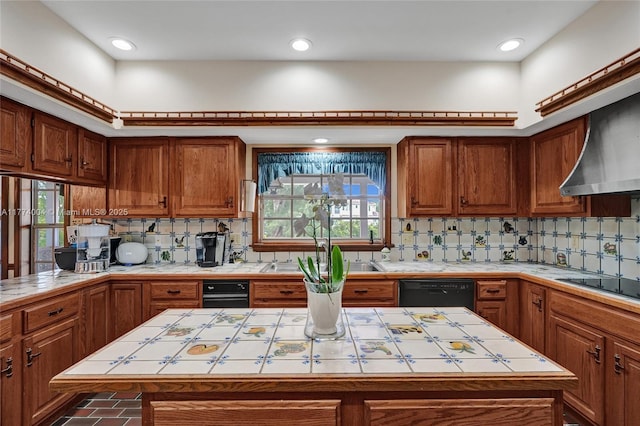 kitchen featuring plenty of natural light, tile counters, brown cabinetry, and a kitchen island